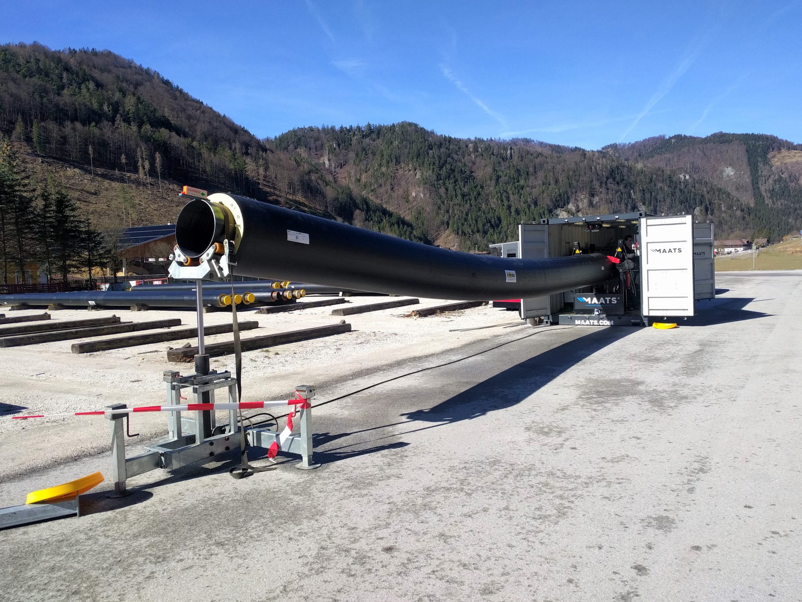 Pipeline bending operation using MAATS internal bending machine in a mountain setting.
