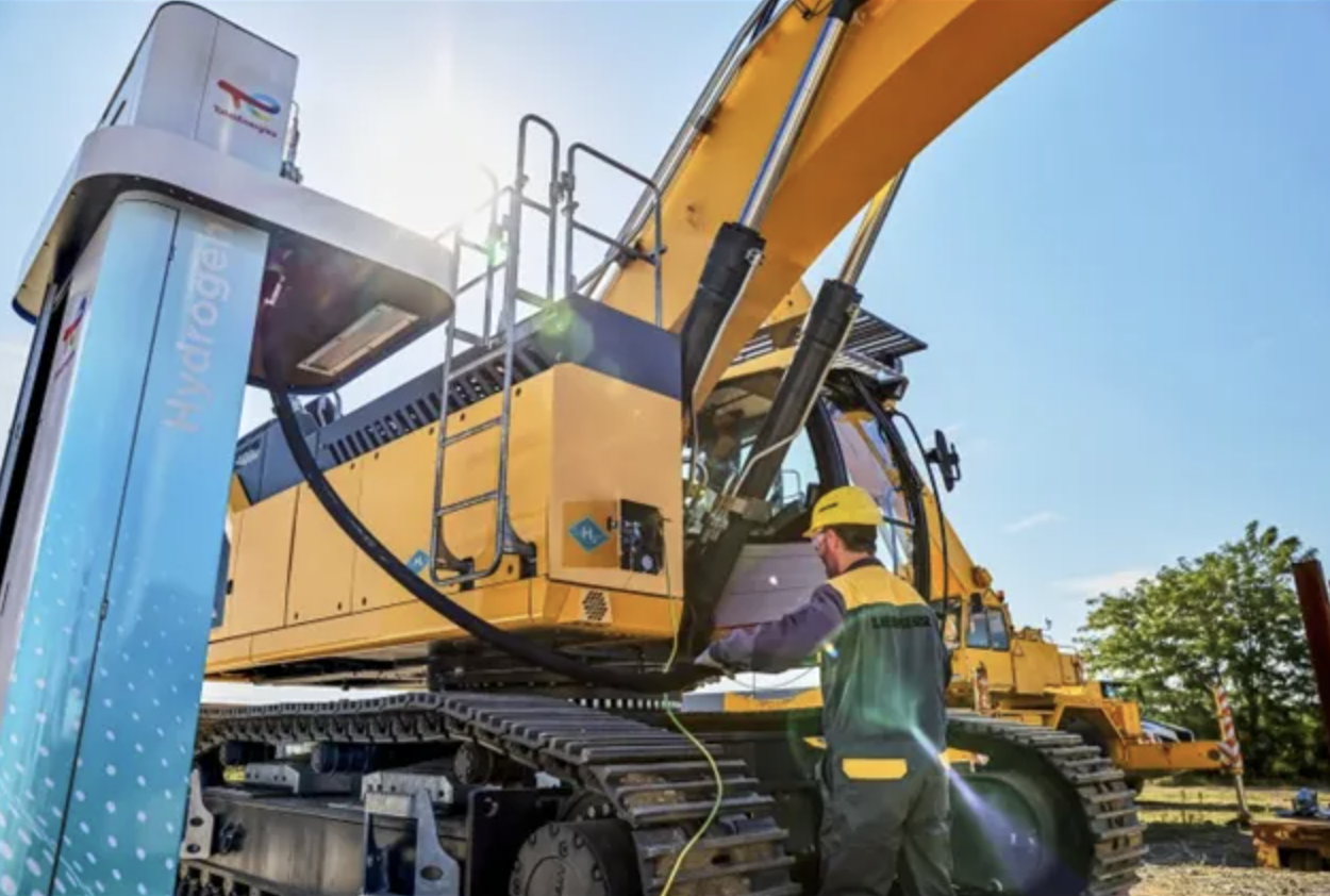 Liebherr construction machine being refueled at a hydrogen station.